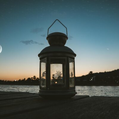 Gray Metal Candle Lantern on Boat Dock